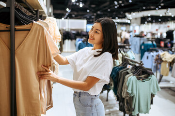 woman choosing clothes in clothing store