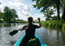 Female Kayaker Enjoys Paddling Through The Channels And Canals O The Spreewald Region In Germany