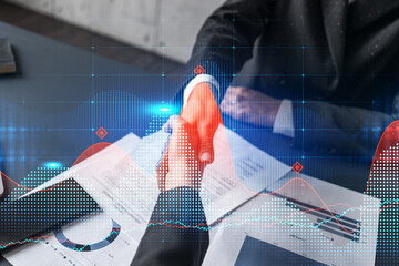 Wall Mural - handshake concept. two business people make a deal. forex graph double exposure.