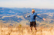 © Svetlana - Carefree man on top of mountains enjoying freedom with arms outstretched. Young tourist man breathing fresh air