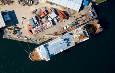 Wall Mural - Shipbuilding construction ship aerial view at shipyard harbour with scaffold