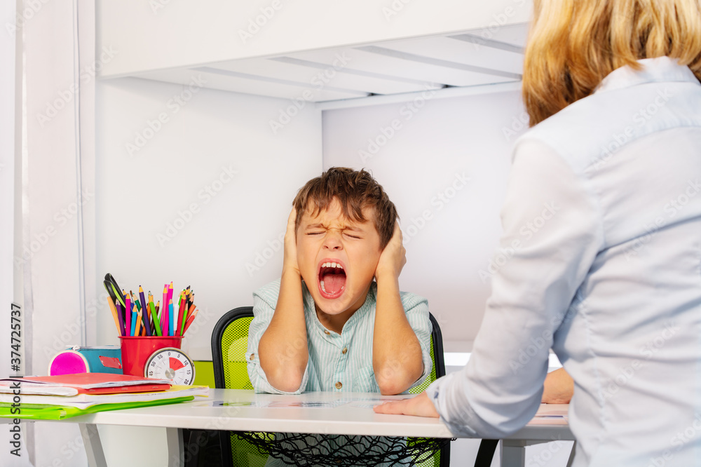 Autistic boy scream and close ears in pain during ABA development ...