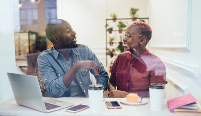 Wall Mural - Freelancers during joyful conversation in cafe