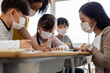 © JR-50 - A group of Kids students wearing medical masks in the classroom.