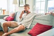© Krakenimages.com - Handsome caucasian man smiling happy sitting on the sofa at home speaking on the phone