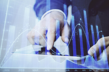 Multi exposure of man's hands holding and using a phone and financial chart drawing. Market analysis concept.