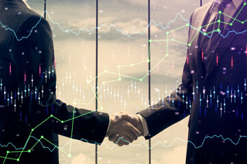 Double exposure of forex graph hologram and handshake of two men. Stock market concept.