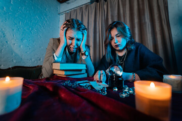 Wall Mural - Fortune teller forecasting the future to woman with cards