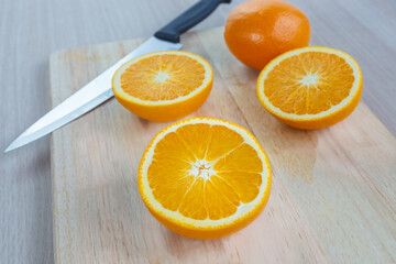 Wall Mural - orange with slices on wooden cutting board