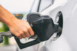 © Maridav - Car pumping gas at gas pump. Closeup of man pumping gasoline fuel in car at gas station.