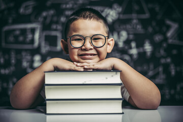 Wall Mural - A boy hugging a pile of books.