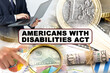 © Dzmitry - A businessman holds a folder with documents, the text on the folder is - AMERICANS WITH DISABILITIES ACT