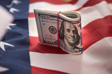 one hundred US dollars with flag of USA