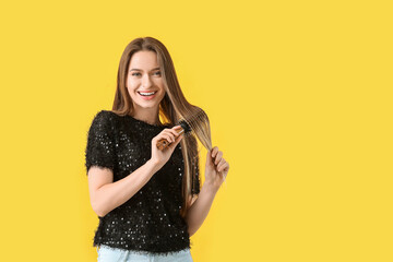 Sticker - Young woman brushing hair on color background