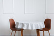 © Pixel-Shot - Dining table near white wall