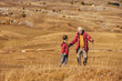 © Mediteraneo - Senior man with grandson on country walk in autumn.