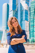 © KseniaJoyg - Portrait of young woman with glass views of business neboskreby