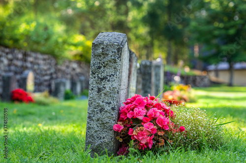 Cuadros en Lienzo Row of grave stones with flowers at a cemetery in Sweden