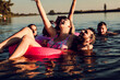 © Zoran Zeremski - Group of young friends having fun and enjoying a summer day swimming at the lake.
