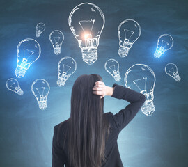 Poster - Young european businesswoman looking on creative  lightbulbs sketch