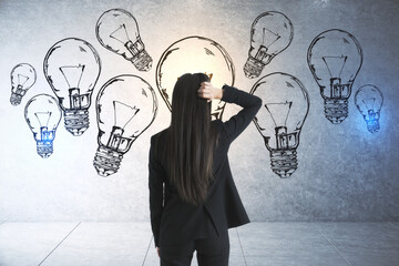 Poster - Thinking businesswoman in suit looking on drawing lamps