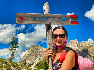 Sticker - Happy woman beginning a mountain excursion in summer