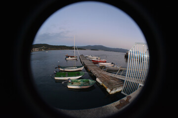 Sticker - Peephole view of a small port with boats in the water