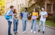 Multiethnic Freshmen Students Talking Walking In University Campus Outside