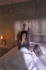 Wall Mural - Woman stretching and yawning in bed