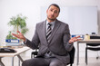 © Elnur - Young male employee working in the office