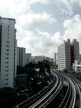 High Angle View Of Railroad Tracks By Buildings Against Sky