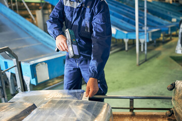 Wall Mural - Baggage department worker scanning a luggage tag