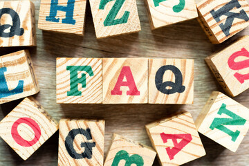 Sticker - Alphabet letter block in word  FAQ (Abbreviation of Frequently Asked Questions) with another on wood background