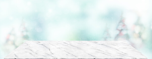 Poster - Perspective marble table with blur Christmas tree decorate string light and blue bokeh with snow light.Panoramic wooden countertop banner mock up for product display for online content