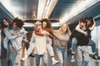 © Alessandro Biascioli - Group young friends having fun piggybacking in underground metropolitan subway - Happy trendy people enjoying nightlife and laughing together - Youth millennial friendship lifestyle concept