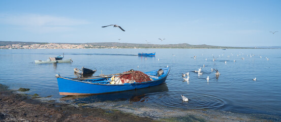 Poster - Boat in the water. Fishing boat in the calm waters of the pond of santa caterina in southern sardinia