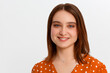 © Bitmap - Close up portrait of smiling young woman in red dress looking at camera, isolated on gray background
