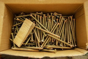 A box full of light brown nails, top view