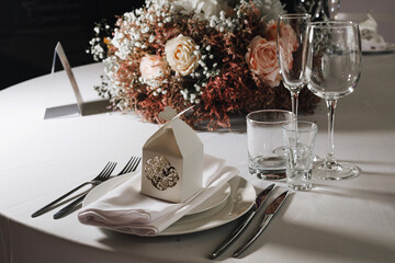 tableware Glasses, flower fork, knife served for dinner in restaurant with cozy interior