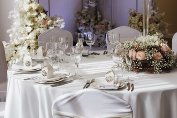 Poster - tableware Glasses, flower fork, knife served for dinner in restaurant with cozy interior