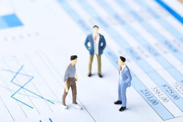 Poster - Miniature people and financial papers with graph and charts