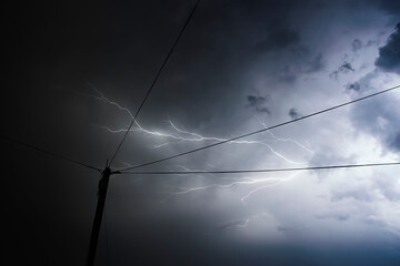 Lightning over the city | thunder storm in massive blue cloud | stormy weather | electricity | electric power energy | electrical cable line | thunder bolt in the sky