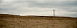 © Darren Muir/Stocksy - Electricity pylons in a barren landscape.