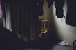 © Rachel Bellinsky/Stocksy - Vintage chair in a basement with hanging laundry