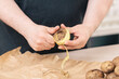 © Photodesign Elisabeth Coelfen/Stocksy - Man peeling potatoes in his kitchen