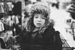 © Sarah Lalone/Stocksy - A little boy in a furry hat crying in a shopping cart.