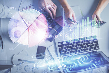 Double exposure of man and woman working together and financial chart hologram drawing. market analysis concept. Computer background. Top View.