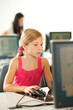 © Sean Locke Photography/Stocksy - Computer Class: Young Girl Uses Computer Mouse to Work