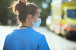 © Alliance - modern paramedic woman with mask outdoors near ambulance
