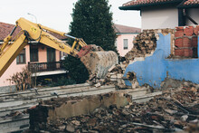 Bulldozer At Work Demolishing Old Building Brick Walls